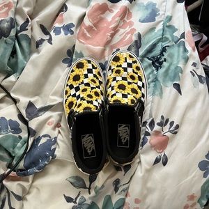 Black and white vans with sunflowers on them